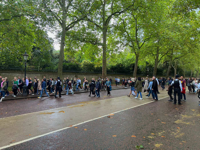 People carrying flowers formed a massive, yet orderly line along Constitution Hill. Most were patiently awaiting their turn to drop flowers in front of the palace.