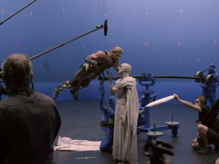 Hemsworth was hoisted into the air using equipment held by two crew members wearing blue suits that were edited out in post-production.