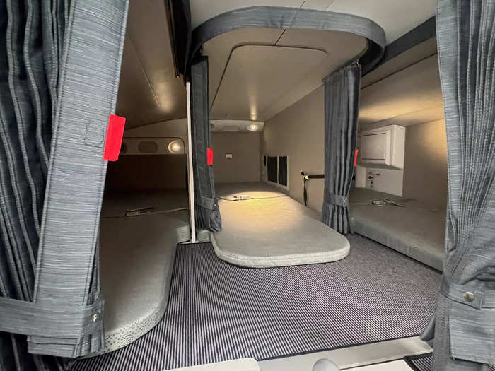 The rest area is situated at the back of the plane and features twin beds, mirrors, storage, and power outlets.