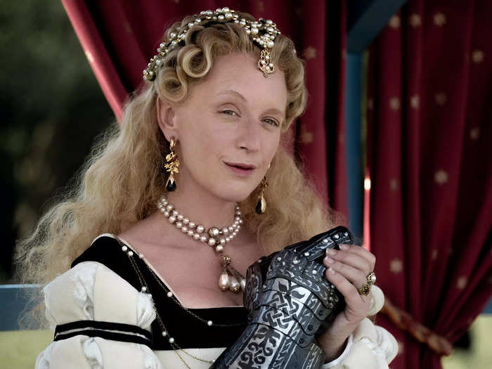 Diane de Poitiers wears a cascade of blonde curls down her back. Her posh look is always grounded by her signature black and white color palette.