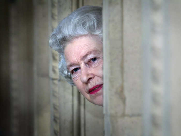 Photographer Tim Graham caught the Queen peeking around a corner at Royal Albert Hall in 2004.