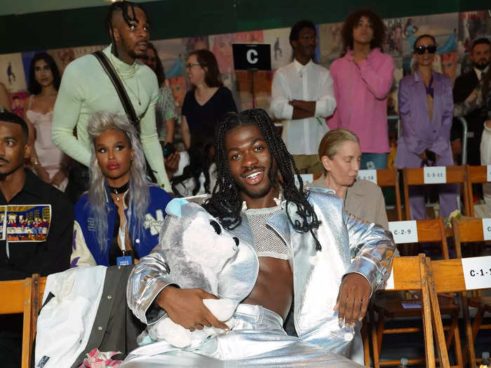 Before performing on the runway, Lil Nas X sat in the audience wearing an eye-catching ensemble.