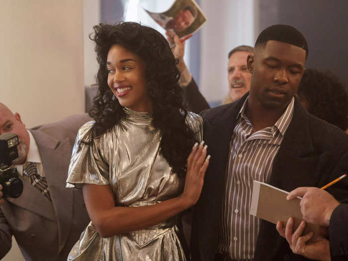 Laura Harrier rocks big hair and bold looks as a fictional Robin Givens. In one scene, she reflects on how she and her beau are Black America