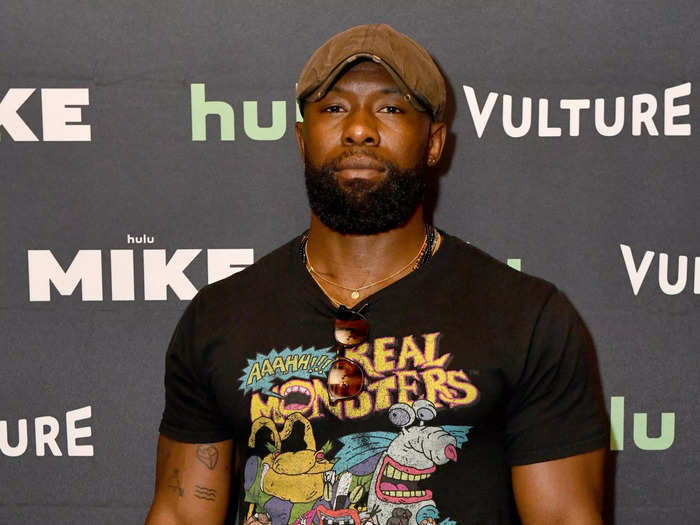 In real life, the "Moonlight" star has a full beard and chooses cartoon tees over slick button-ups.