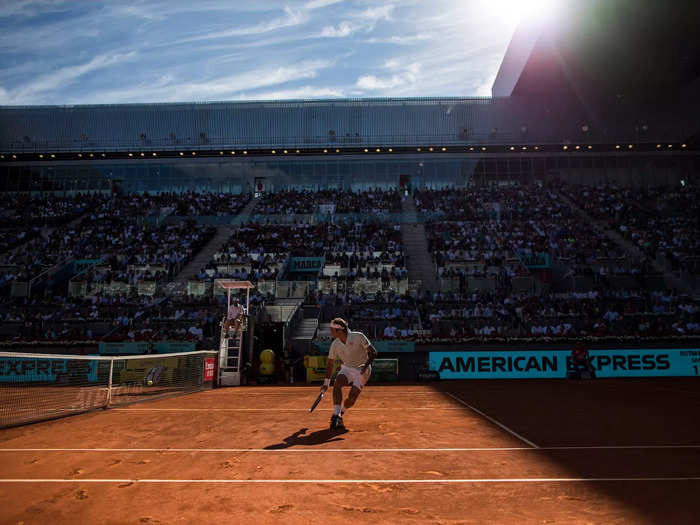 Federer runs to the net under blue skies at the Madrid Open