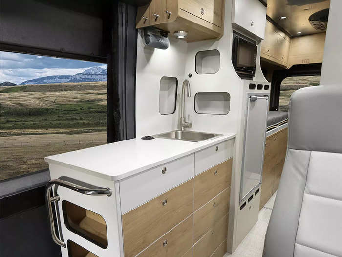 As always, storage is plentiful inside the camper van with features like gear storage panels on the rear doors and cubbies by the entry door.