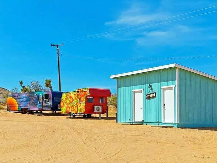 The outhouse is located in between the three trailers.