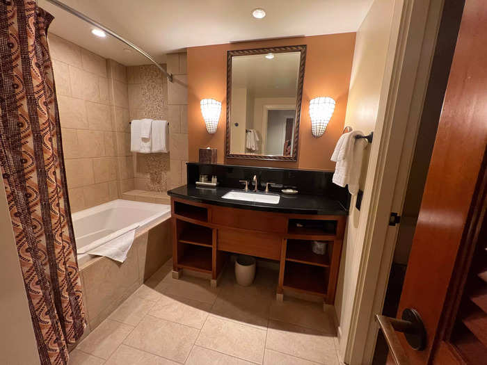 I also thought the bathroom was spacious with plenty of shelving, a rainfall-style shower and bath, a large counter, and separate toilet. It came stocked with Disney