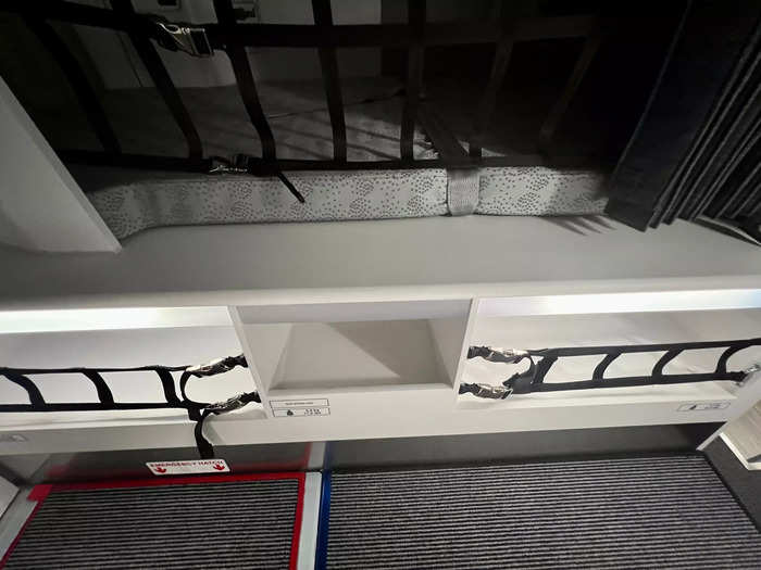 Under each center bunk is a designated space for bags and other necessities.