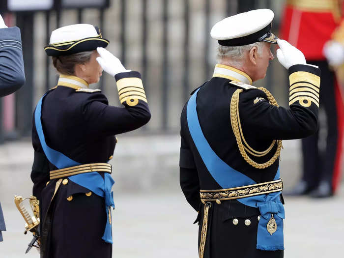 Princess Anne and King Charles III saluted their mother as she was carried into the abbey.