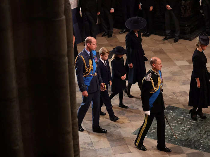 The prince and princess walked between their parents as they processed behind the Queen