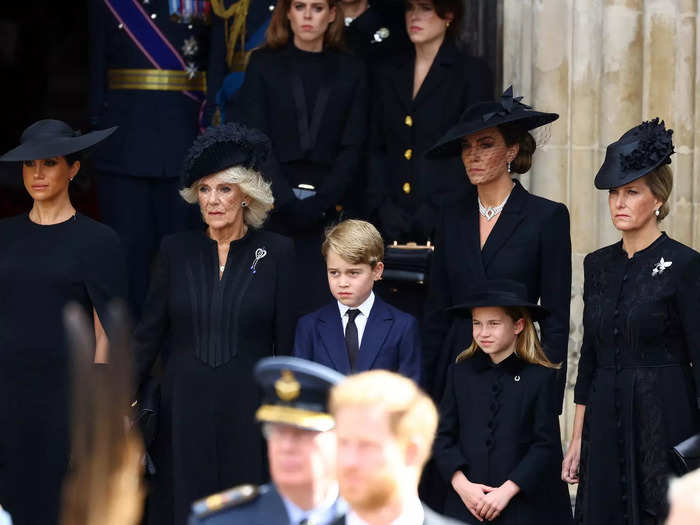 Meghan and Kate watched as their husbands and other members of the royal family walked behind the Queen