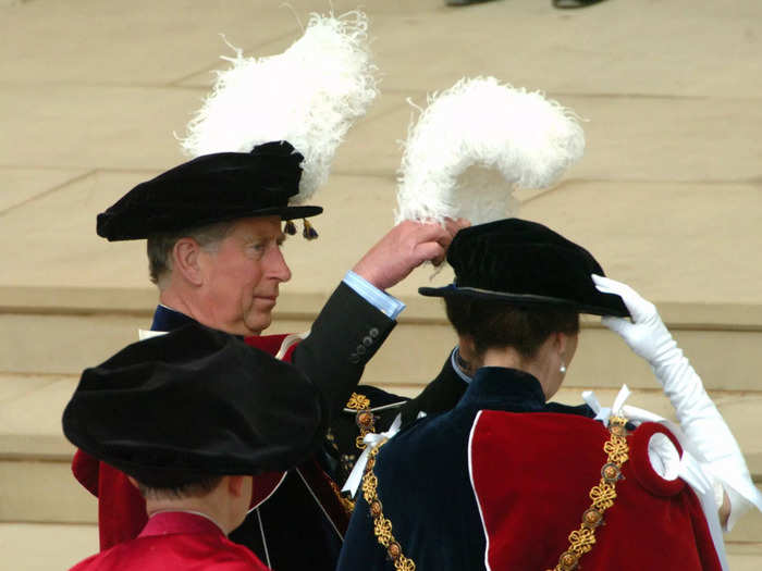 Photographers captured a sweet moment between the two as Charles helped Anne fix the plume on her hat in 2005.