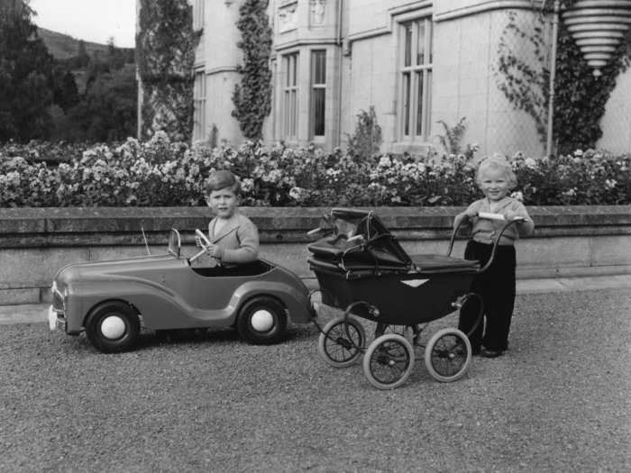 Charles and Anne entertained themselves with toy cars and strollers at Balmoral Castle in 1952.