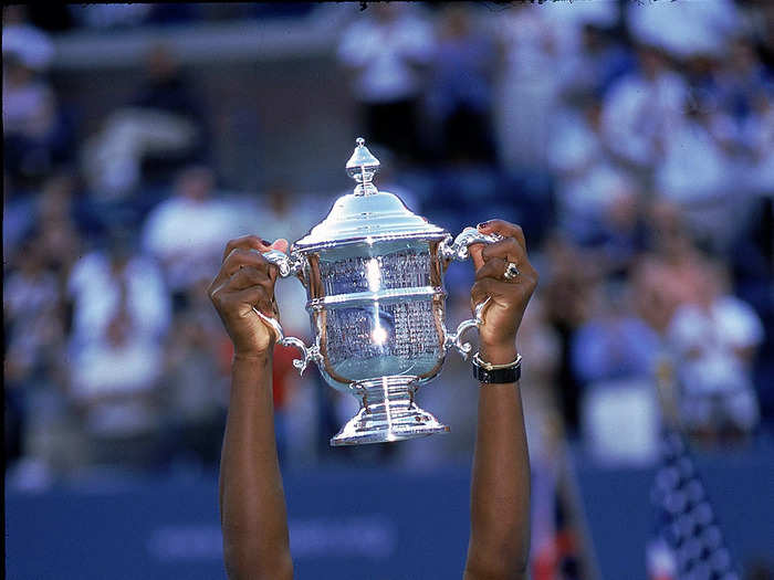 1999: Serena Williams holds up her trophy after winning her very first Grand Slam title at the 1999 US Open.