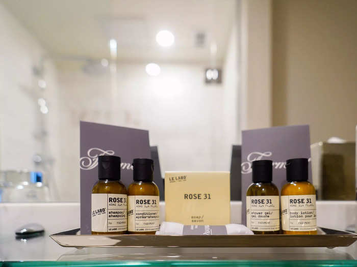 Above the sink, Le Labo toiletries were provided including shampoo, conditioner, and body lotion.