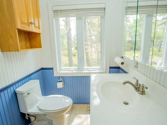 The bathroom has big windows with beautiful views.