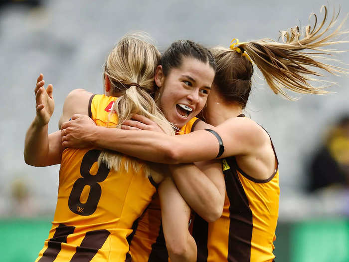 8/14: Dominique Carbone of the Hawthorn Hawks celebrates a goal during her team