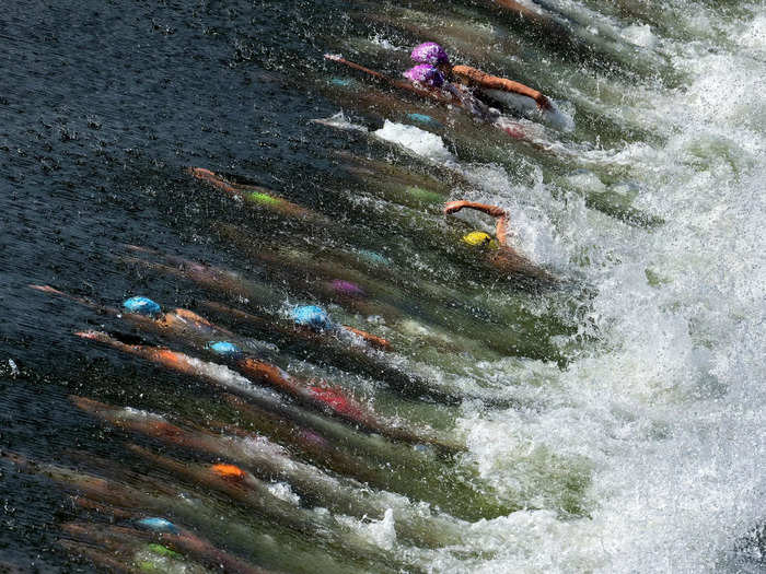 8/12: Athletes compete in the swimming stage of the Women