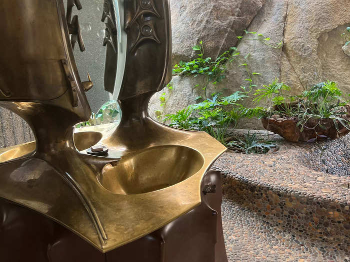 The master bathroom vanity was crafted with wood and bronze.