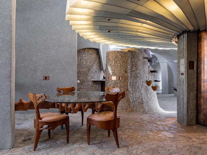 The dining table extends from the wall and is carved from marble. Each chair around it is unique.