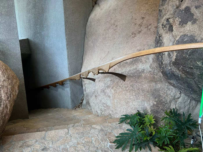 A staircase leads down to one of the three bedrooms.