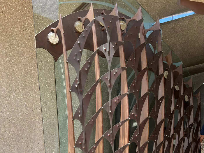 The unique front door is made with glass and metal.