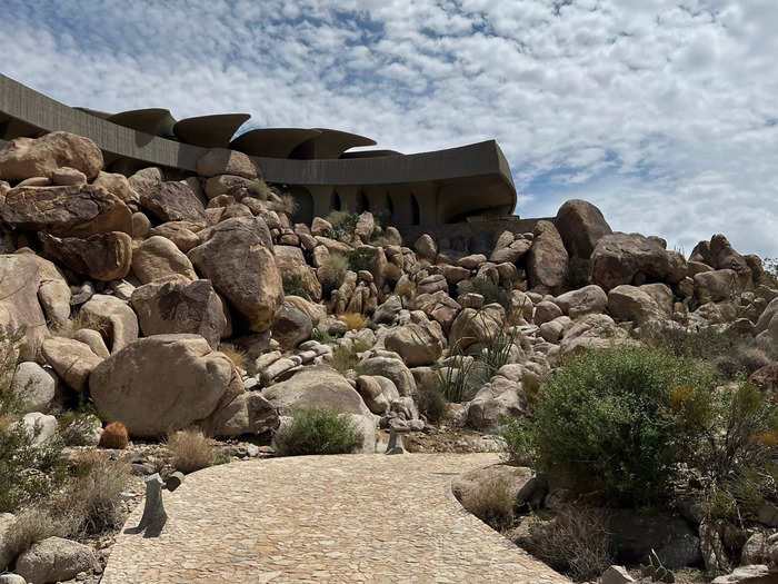 The home, which consists of an elevated main house and a smaller apartment and garage at street level, has a hand-laid stone walkway that runs 500 feet. The same stone flooring continues throughout the home.