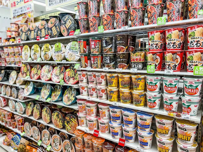 An array of prepackaged ramen, rice, and curry line the shelves.