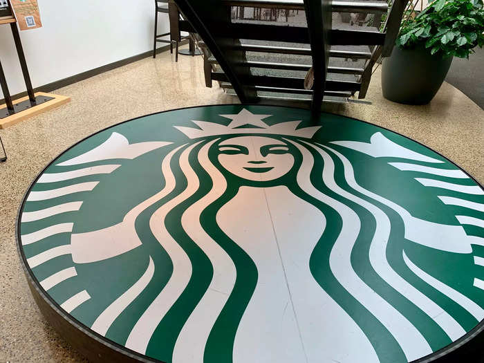 One of the biggest versions of the Starbucks logo sits right next to the coffee plants.