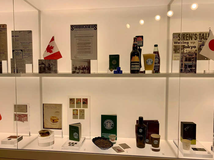 A museum-like display behind glass shows some of the most significant pieces of Starbucks history.