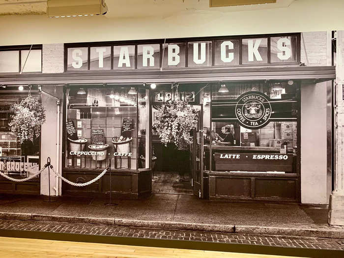 Another wall is completely covered in an image of the Pike Place Market Starbucks.