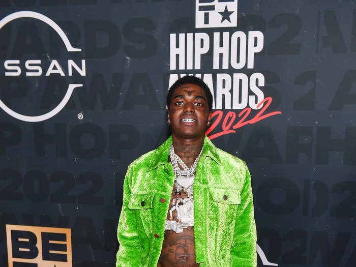 Rapper Kodak Black opted for a neon green velvet ensemble, which he paired with multiple silver chains and rings.