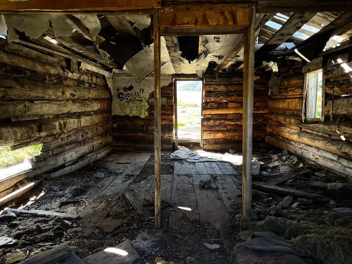 I continued along the trail and spotted more empty, eerie buildings. I peeked inside one, where I saw insulation was peeling from the ceiling and floorboards that had chipped away over the years.