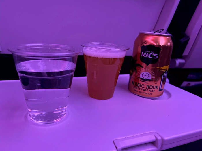 There were several drink options, like beer, wine, spirits, water, soda, coffee, tea, and juice. I opted for a beer and water and stowed it on the tray table next to me, which was another perk of having a row to myself.