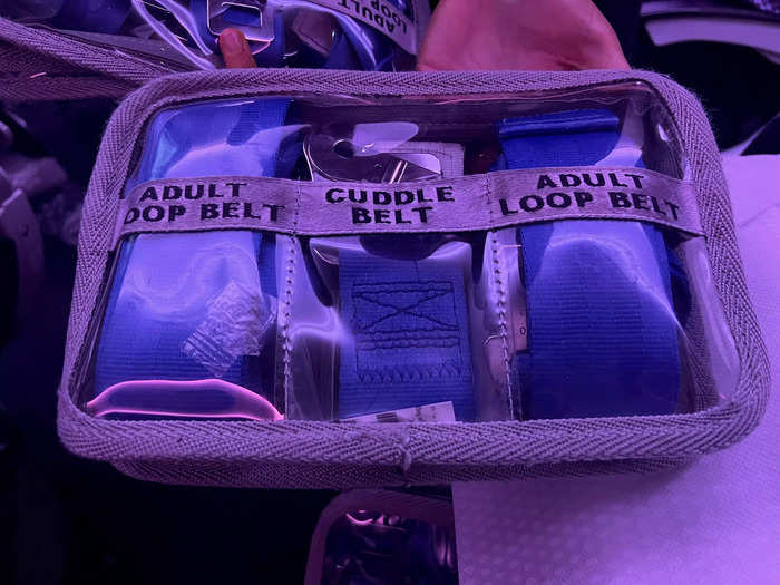 Shortly after takeoff, the flight attendant came by and gave me two special seatbelts, including a "cuddle belt" and an "adult loop belt."