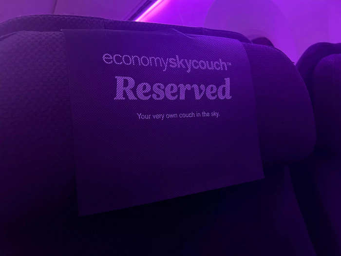 Approaching the row, I immediately noticed a few things. First, the headrests had signs saying "reserved" in big letters, likely to deter regular economy passengers from unknowingly moving to a Skycouch seat.