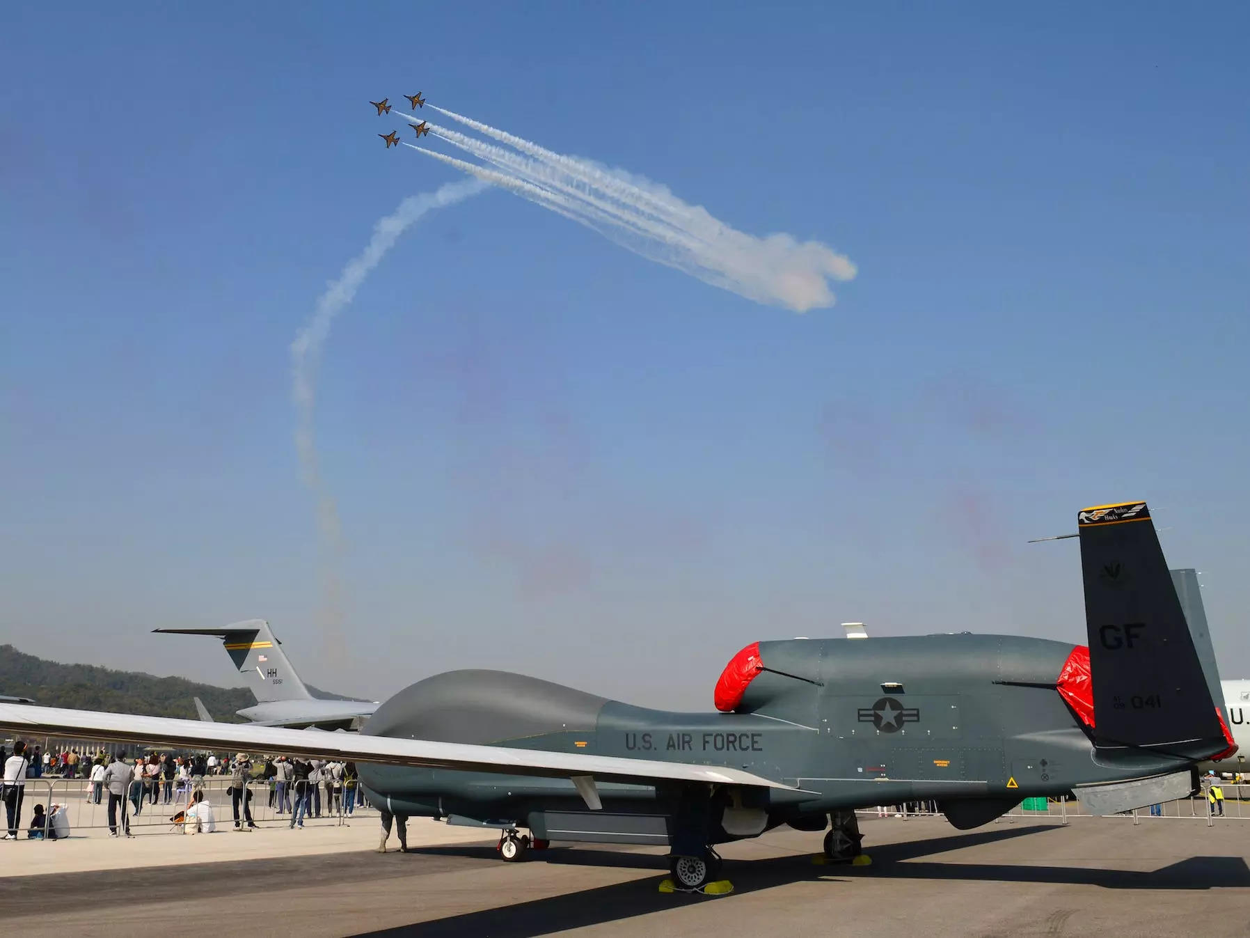 South Korean Black Eagles aerobatic team fly over RQ-4 Global Hawk