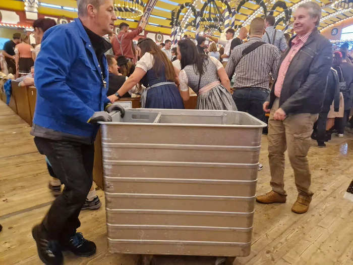 Metal trolleys filled with plates and glasses plowed through the crowds.