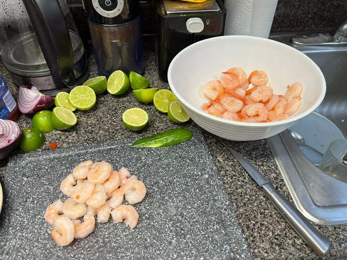 Once the shrimp defrosts, begin pulling the tails off and finely chop the shrimp into smaller bits.