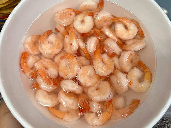 I placed the bag of frozen shrimp into a bowl of cool water and let it defrost for 30 minutes.