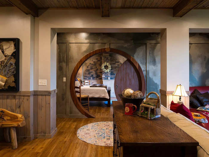 A wooden pocket door leads guests from the living room to the master bedroom.