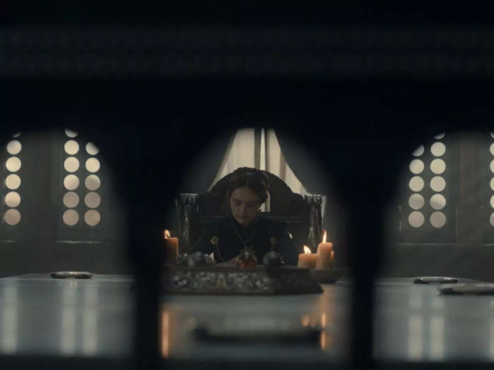 When Alicent is expressing "uneasiness" about siding with Vaemond, the camera angle shows us the Queen through the openings in the chair where Lord Corlys once sat.