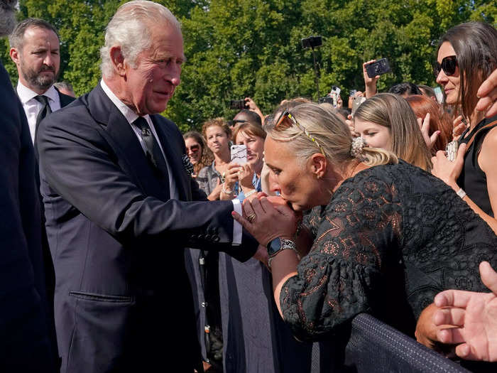 Charles received a warm welcome from the public, with one woman kissing his hand while others chanted "long live the king."