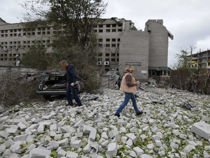 Local residents walk through the rubble of a damaged building in Dnipro, Ukraine.