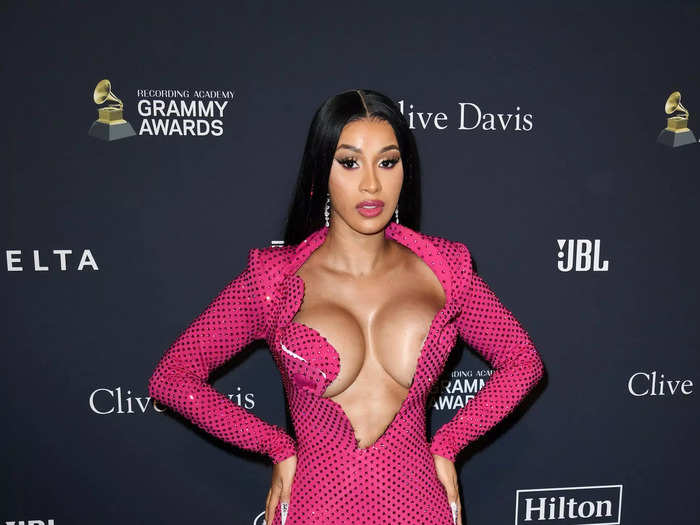 Cardi B walked the red carpet of the 2020 Pre-Grammy Gala in a shimmering pink dress with an ultra-daring neckline.