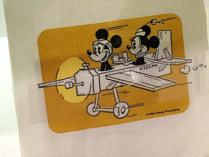 Cocktail napkins featured pilot Mickey and stewardess Minnie flying on a patched-together cartoon plywood prop plane version of N234MM – the same tail number as Mickey Mouse One.