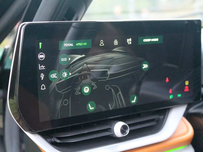 The touchscreen on the left controls the seats, steering wheel, and mirrors.