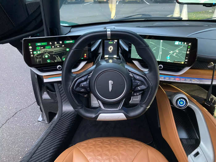 All the screens and dials are angled toward the driver, creating a cockpit that feels more like a fighter jet than any car.