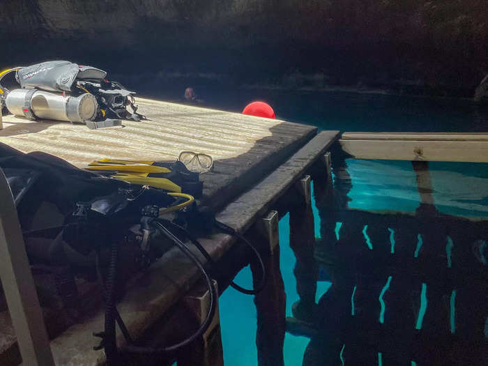 I strapped on my scuba gear and jumped in. As warm water enveloped my body, we sank and swam circles around the limestone walls.